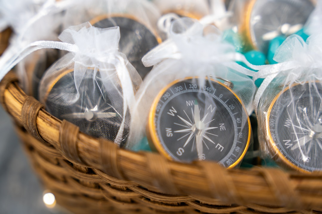 A basket of gold-rimmed compasses, each wrapped in a sheer drawstring bag, offers a symbolic and thoughtful touch. These meaningful tokens reflect the “True North” theme at Deliberate Directions, reinforcing ideas of clarity, vision, and guided leadership. The soft textures and natural materials create a welcoming, intentional aesthetic aligned with purpose-driven growth.